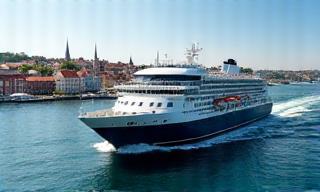 Ferry arriving at a sunny port with historic buildings